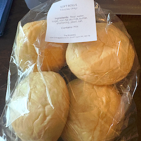 a bag containing four soft dinner rolls